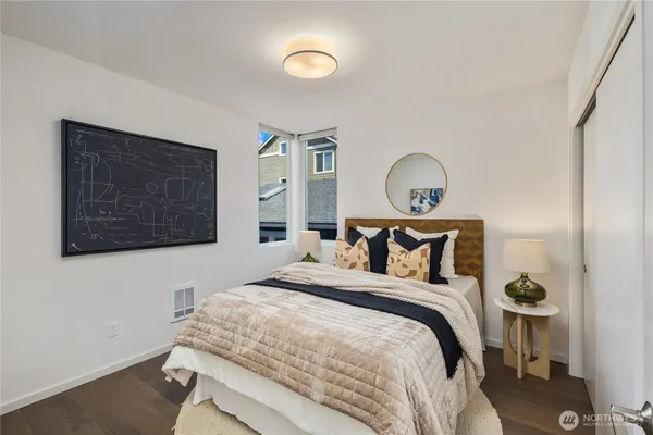 a bedroom with a bed and a wall painting
