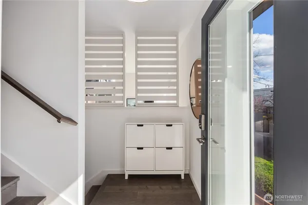 a view of walk in closet with window and entryway