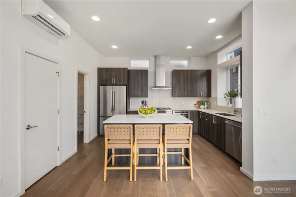 a kitchen with kitchen island wooden cabinets and stainless steel appliances