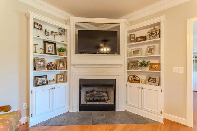 a living room with a fireplace and a flat screen tv