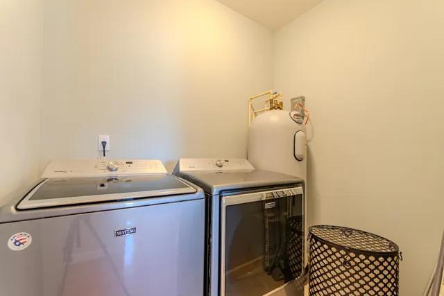 a utility room with a sink dryer and washer