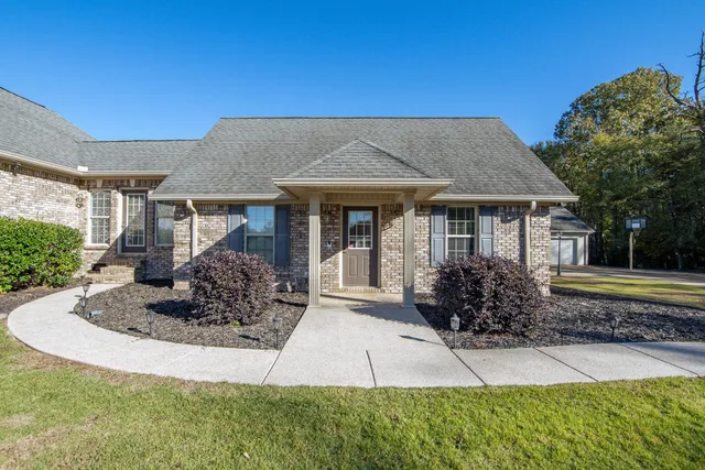 a front view of a house with garden