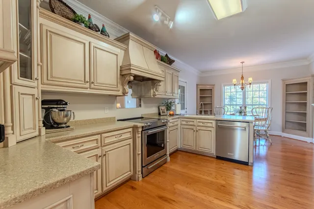 a kitchen with stainless steel appliances granite countertop a stove and a sink