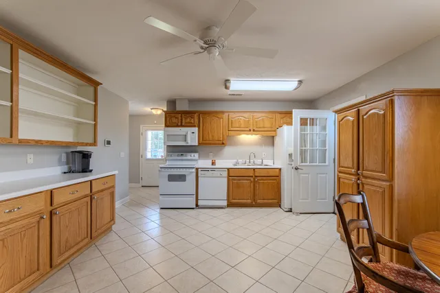 a kitchen with a refrigerator a sink and dishwasher with a large window