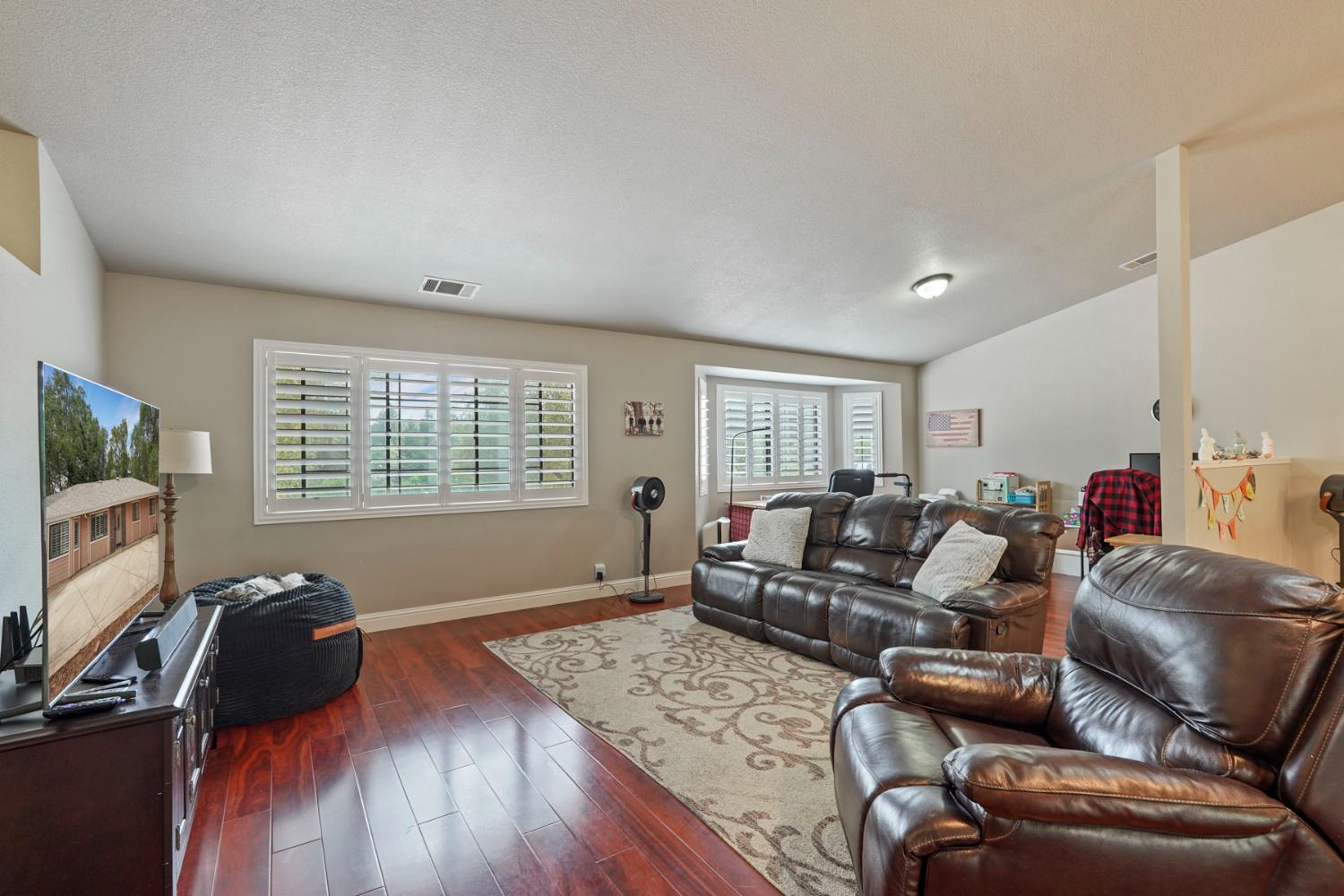 3234 Cambridge Road Cameron Park, CA 95682 - Photo 26 of 42 a living room with furniture and a flat screen tv