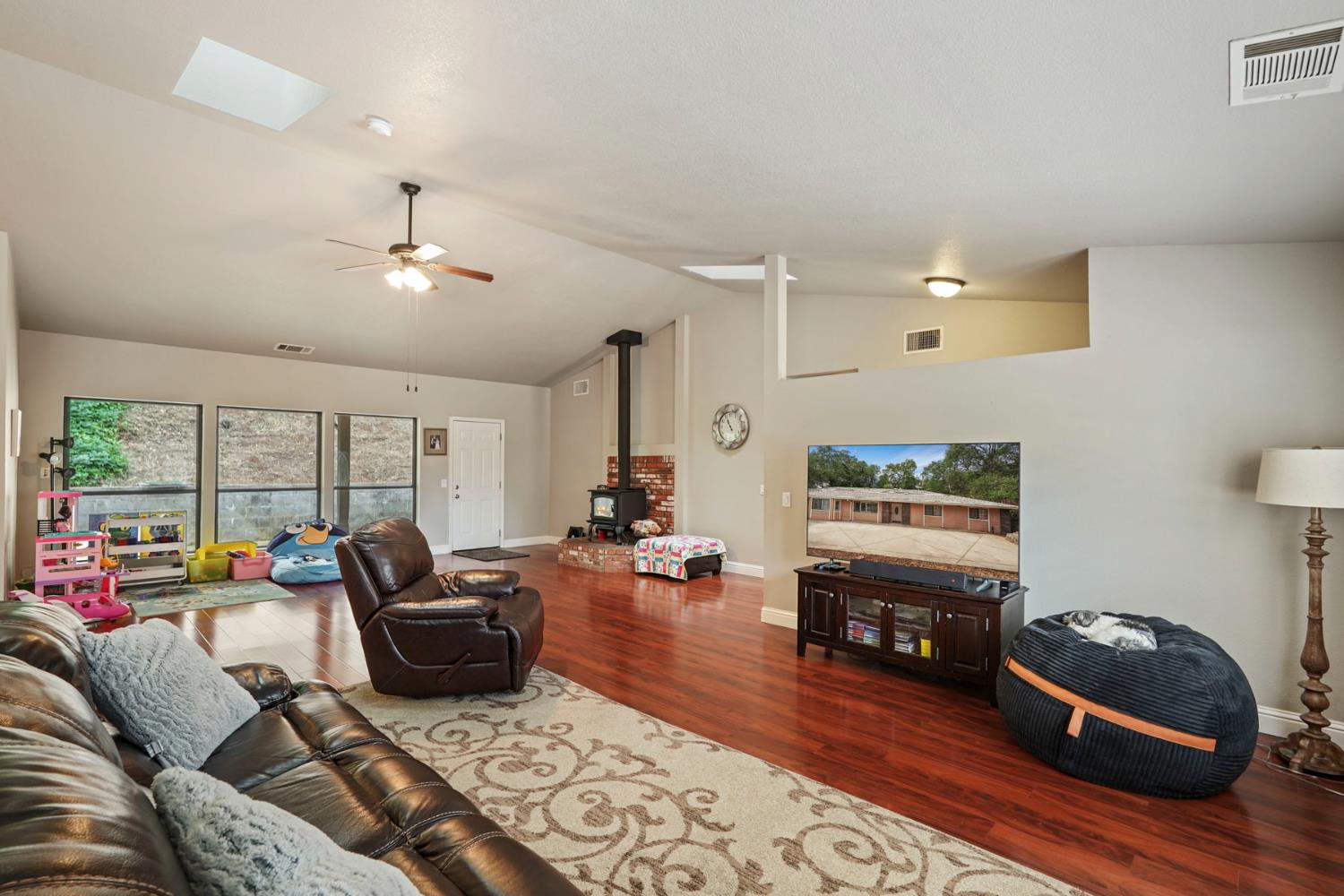 3234 Cambridge Road Cameron Park, CA 95682 - Photo 29 of 42 a living room with furniture and a flat screen tv