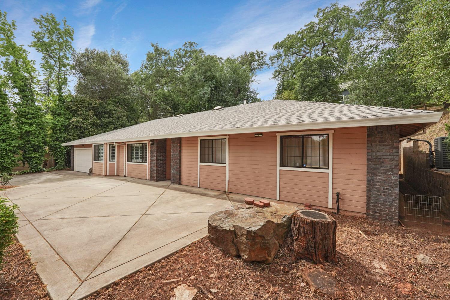 3234 Cambridge Road Cameron Park, CA 95682 - Photo 3 of 42 a house with trees in the background