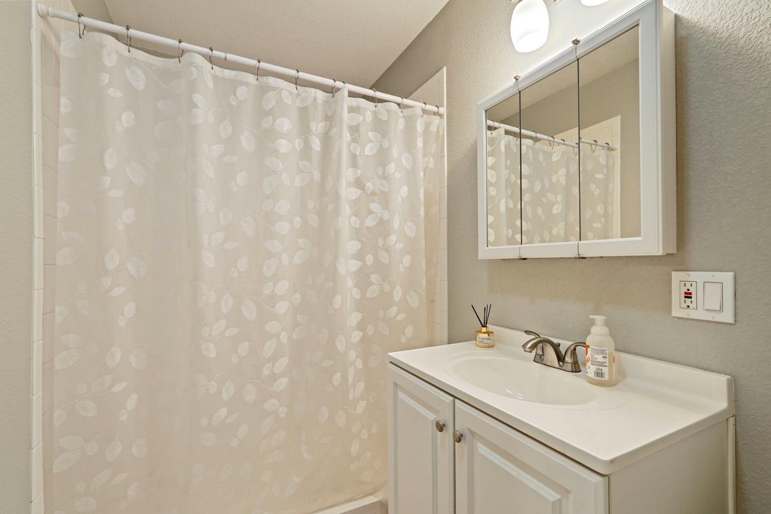 3234 Cambridge Road Cameron Park, CA 95682 - Photo 32 of 42 a bathroom with a sink and a mirror