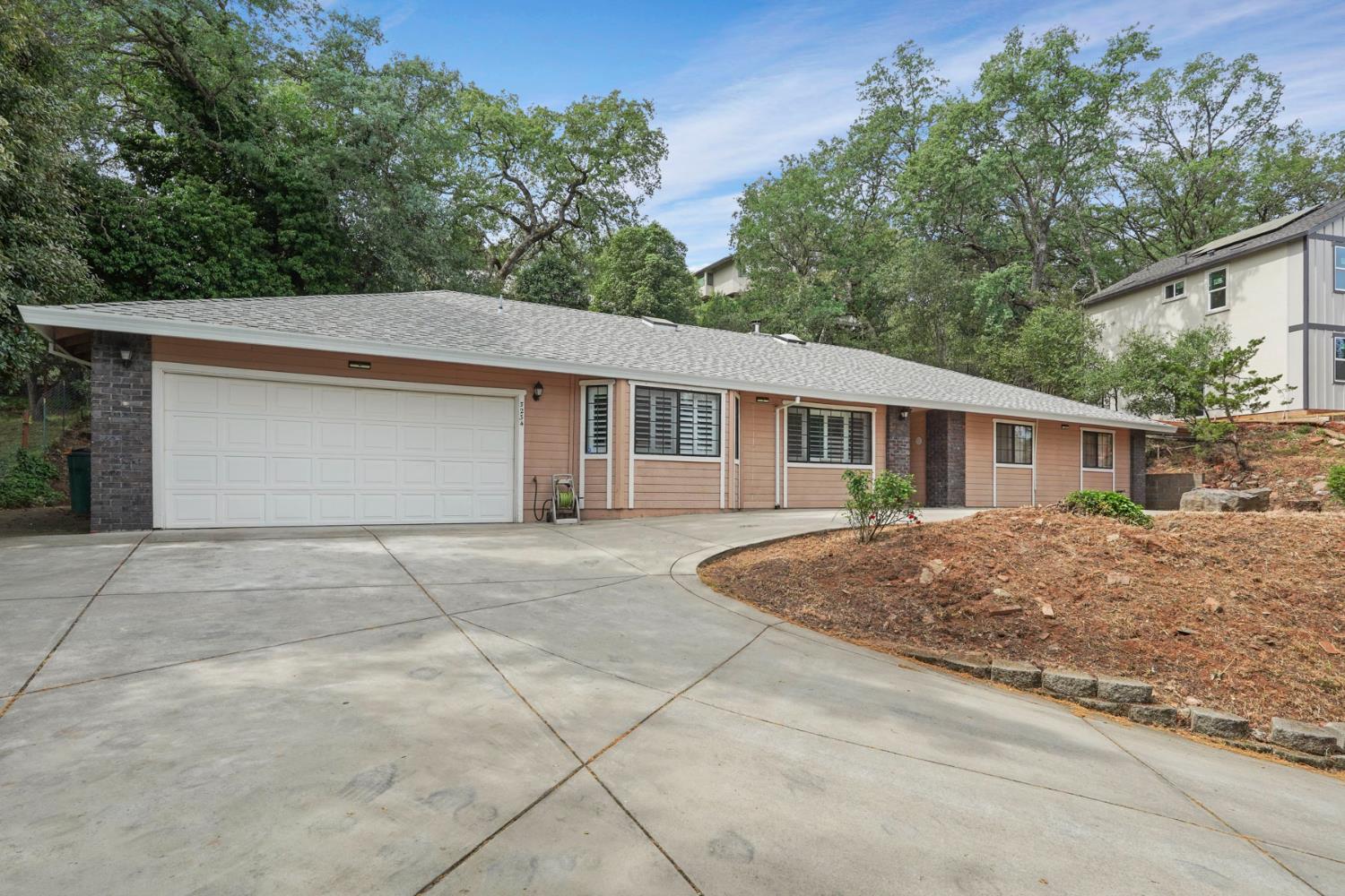 3234 Cambridge Road Cameron Park, CA 95682 - Photo 40 of 42 a view of a house with a yard and large tree