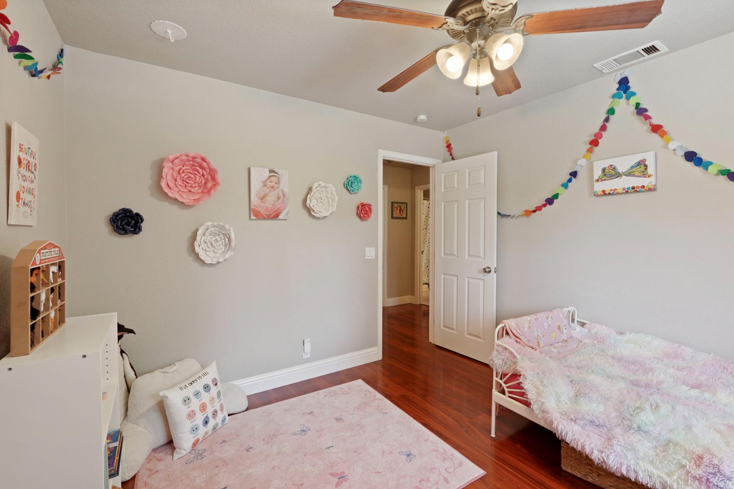 3234 Cambridge Road Cameron Park, CA 95682 - Photo 7 of 42 a bedroom with a bed and wooden floor