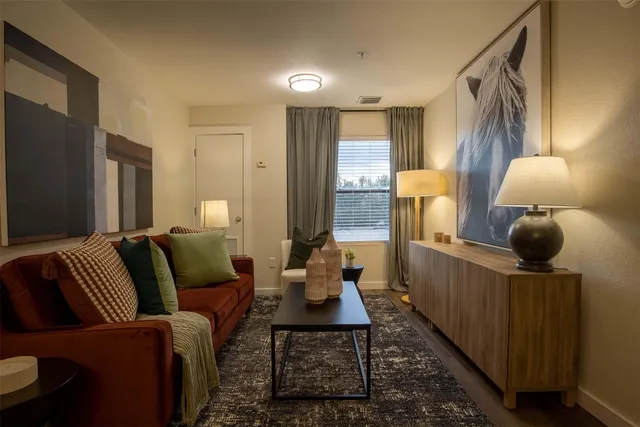 a living room with furniture and wooden floor