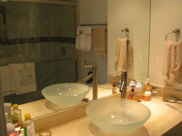 a bathroom with a tub sink and mirror