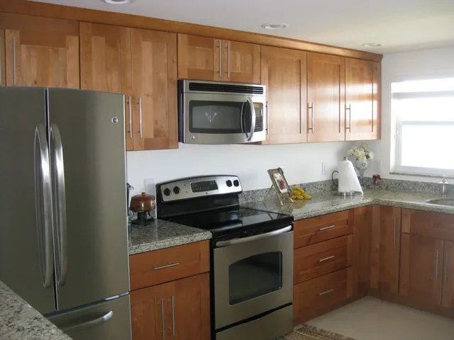 a kitchen with a sink stove and microwave