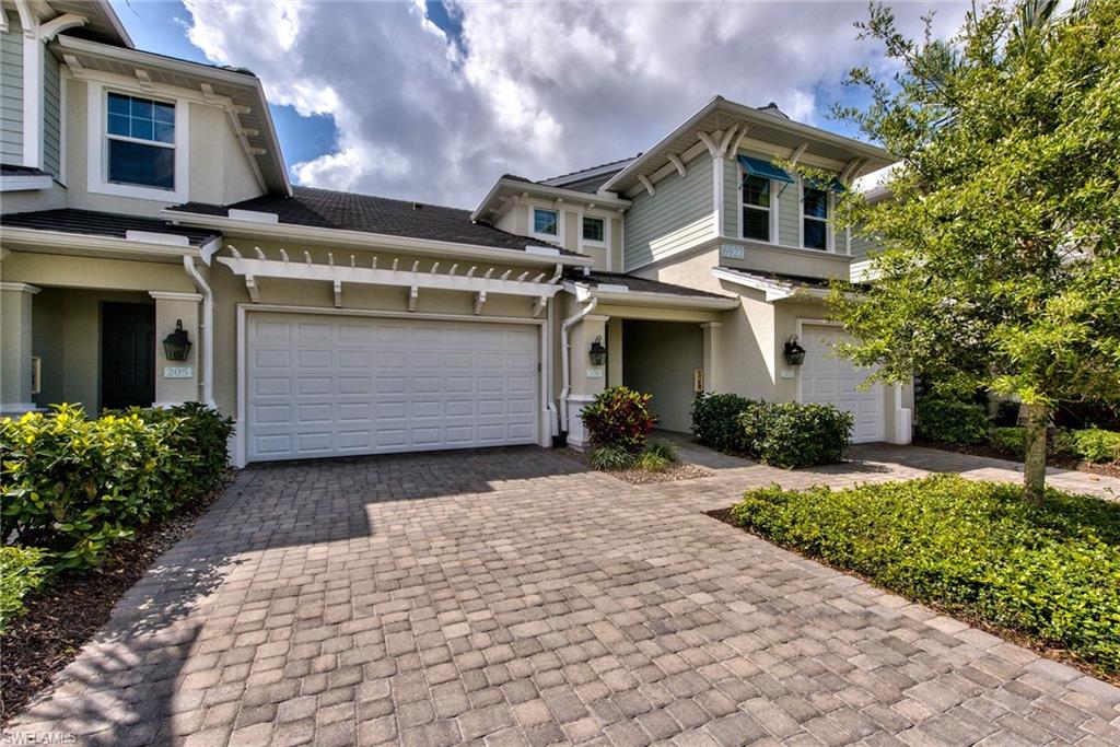 6922 Avalon Circle, Unit 206 Naples, FL 34112 - Photo 1 of 32 a front view of a house with a yard
