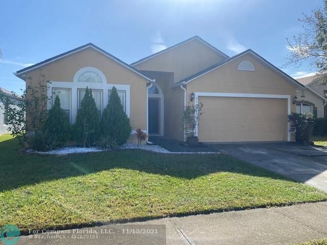 2147 Marisol Loop Kissimmee, FL 34743 - Photo 1 of 20 a front view of a house with garden