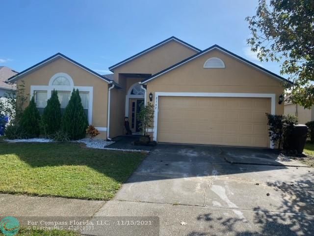 2147 Marisol Loop Kissimmee, FL 34743 - Photo 2 of 20 a front view of a house with a yard and garage