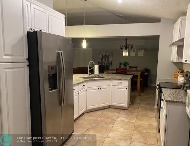 2147 Marisol Loop Kissimmee, FL 34743 - Photo 12 of 20 a kitchen with stainless steel appliances a refrigerator sink and stove