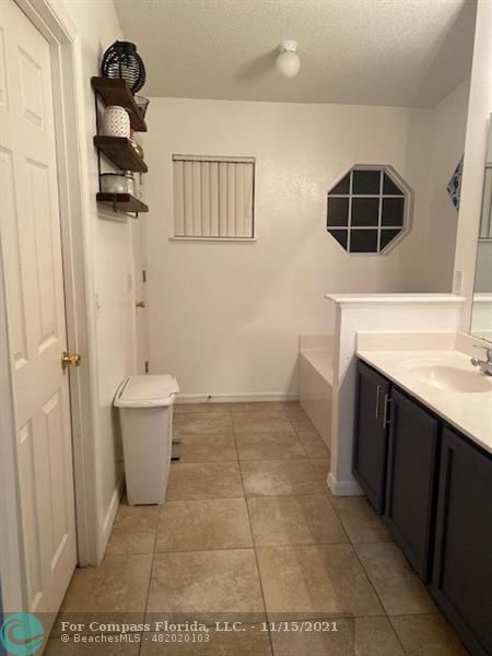 2147 Marisol Loop Kissimmee, FL 34743 - Photo 16 of 20 a bathroom with a sink and a mirror