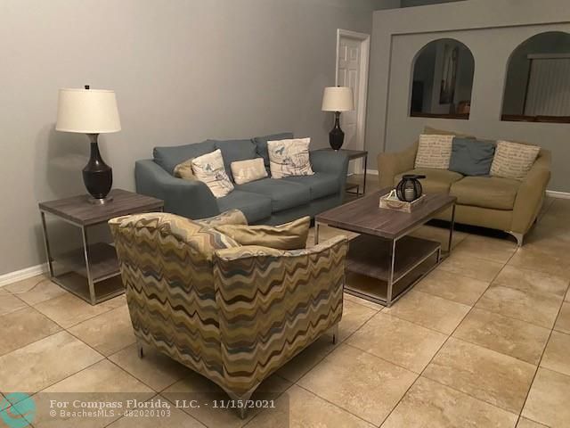 2147 Marisol Loop Kissimmee, FL 34743 - Photo 6 of 20 a living room with furniture and a lamp