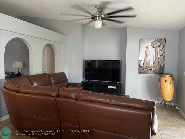 2147 Marisol Loop Kissimmee, FL 34743 - Photo 8 of 20 a living room with furniture and a flat screen tv