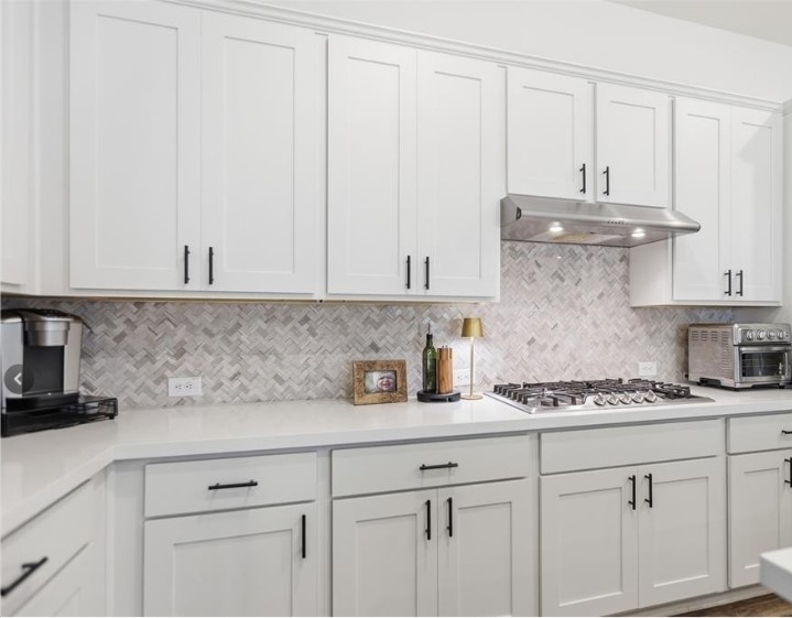 544 Cherrystone Loop Buda, TX 78610 - Photo 11 of 40 a kitchen with white cabinets and white appliances
