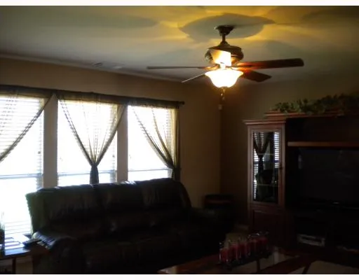 a view of a livingroom with a ceiling fan and window
