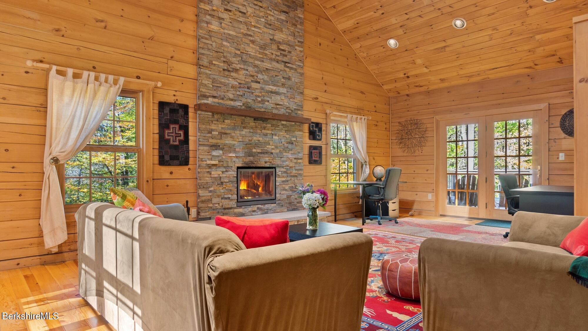 140 Lenox Branch Road Richmond, MA 01254 - Photo 8 of 35 a living room with furniture a fireplace and a large window