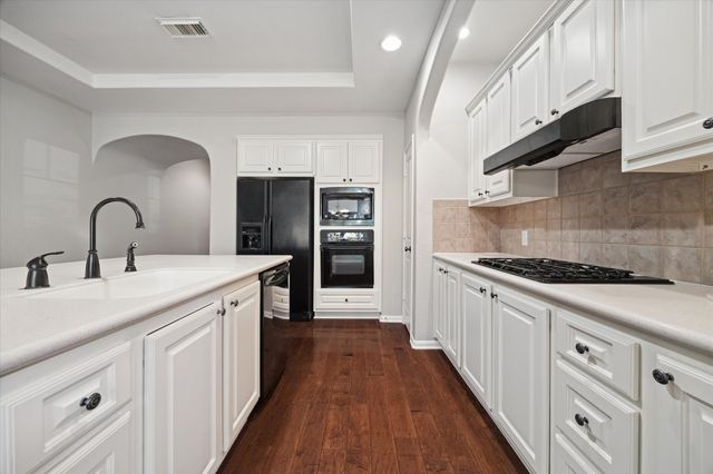 a kitchen with sink a stove and refrigerator