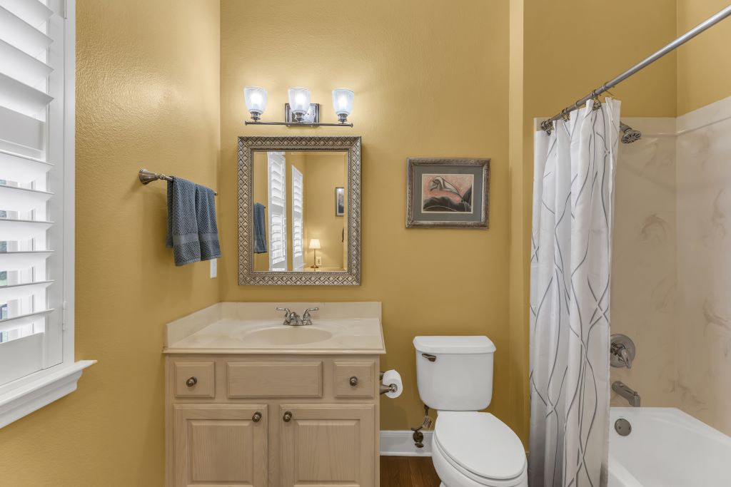 144 Cattle Trail Way Georgetown, TX 78633 - Photo 23 of 37 A well-appointed bathroom offers a classic vanity, pristine commode, and an inviting bathtub.