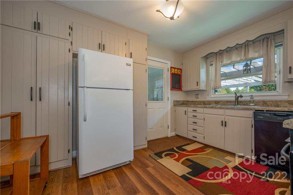 176 Crestview Street Rutherfordton, NC 28139 - Photo 13 of 38 a kitchen with granite countertop a refrigerator a sink and a stove