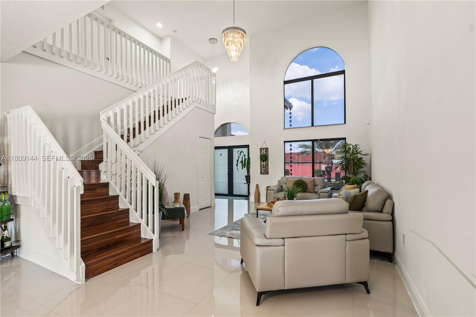 3801 Southwest 149th Avenue Miami, FL 33185 - Photo 11 of 41 a living room with furniture and a chandelier