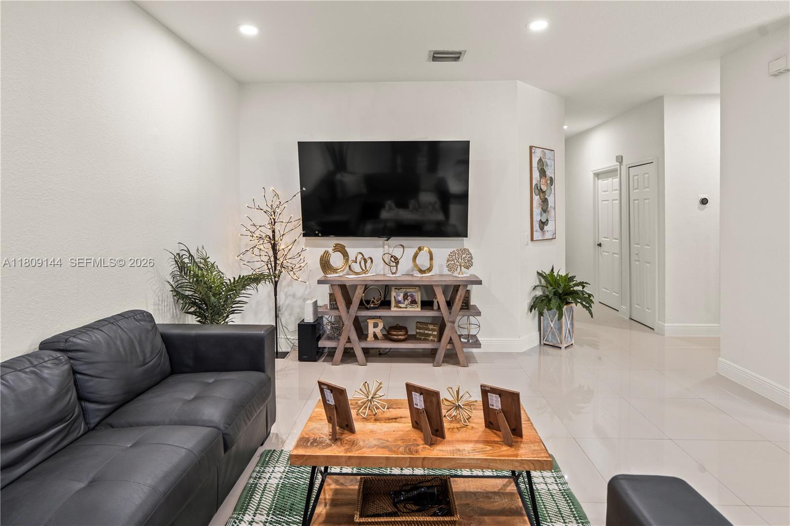 3801 Southwest 149th Avenue Miami, FL 33185 - Photo 17 of 41 a living room with furniture and a flat screen tv