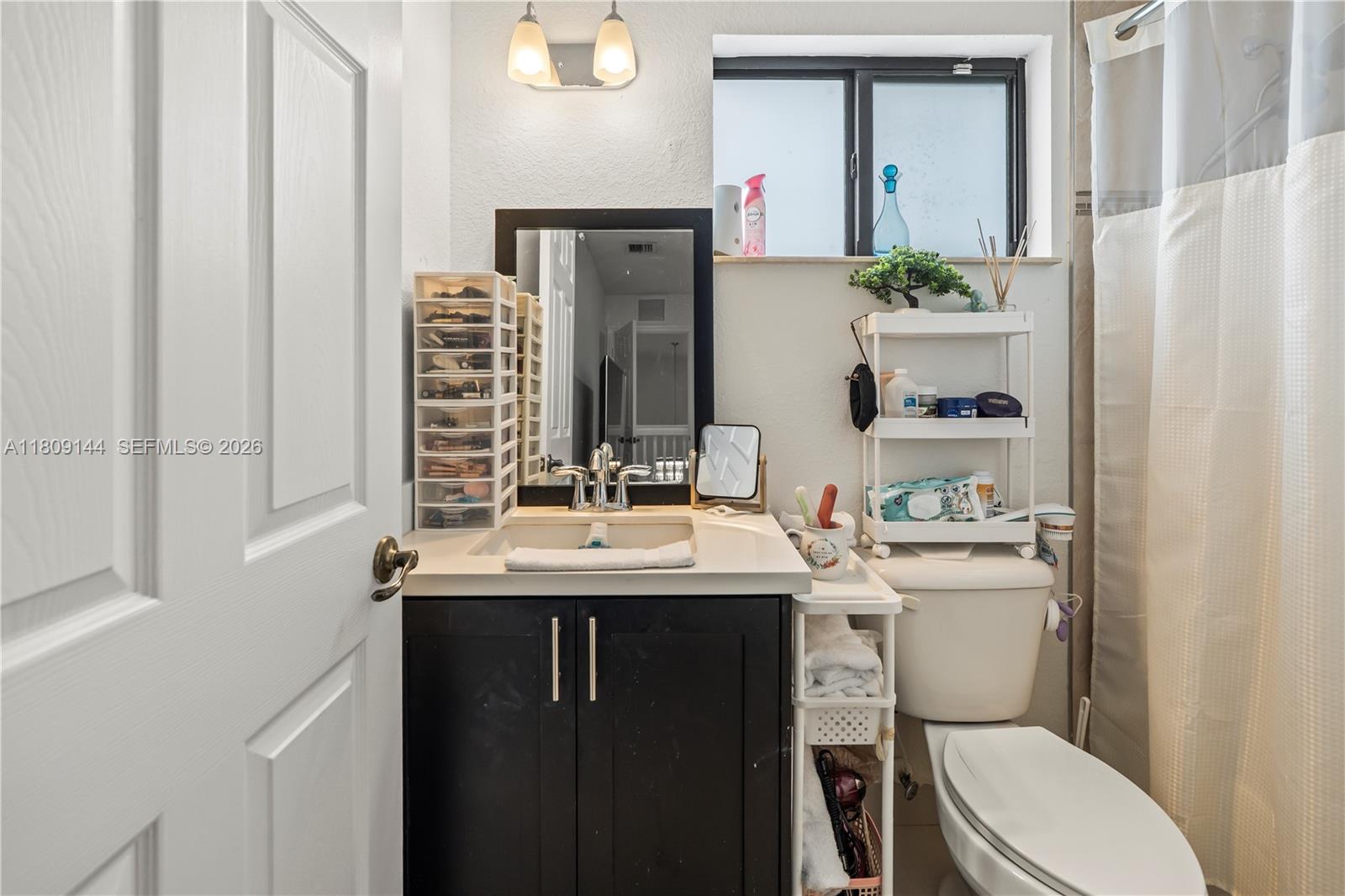 3801 Southwest 149th Avenue Miami, FL 33185 - Photo 20 of 41 a bathroom with a sink toilet vanity and window