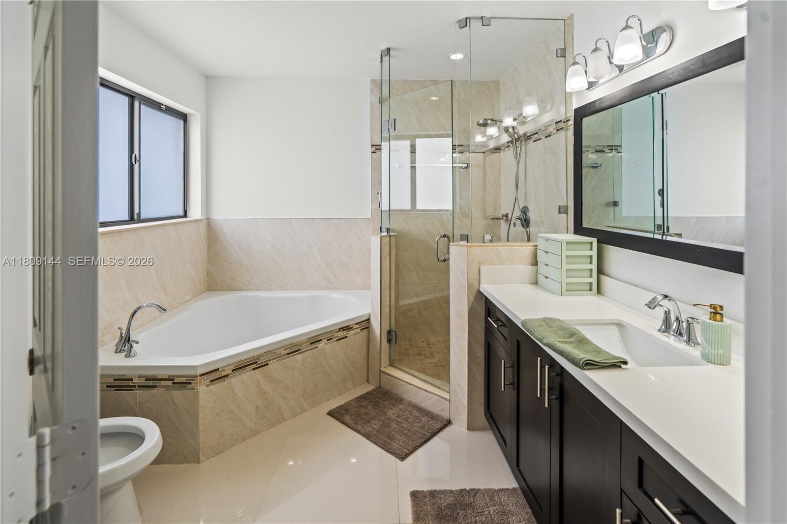 3801 Southwest 149th Avenue Miami, FL 33185 - Photo 25 of 41 a bathroom with a tub a sink a toilet and mirror