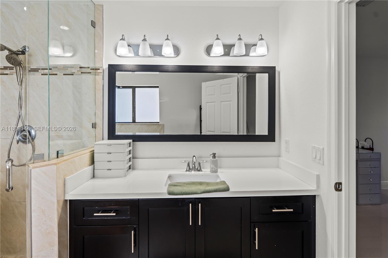 3801 Southwest 149th Avenue Miami, FL 33185 - Photo 26 of 41 a bathroom with a sink vanity and a mirror