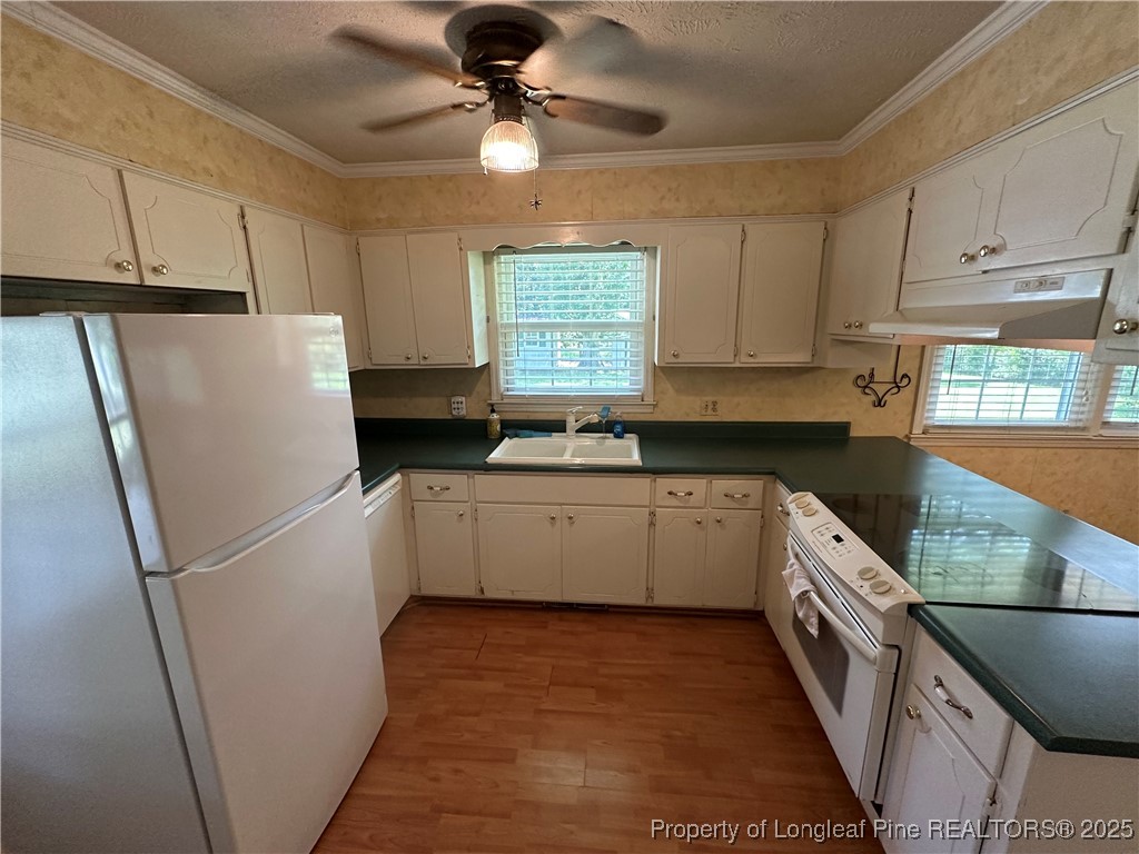 3120 Hampstead Road Lumberton, NC 28360 - Photo 13 of 30 a kitchen with a refrigerator a sink and dishwasher