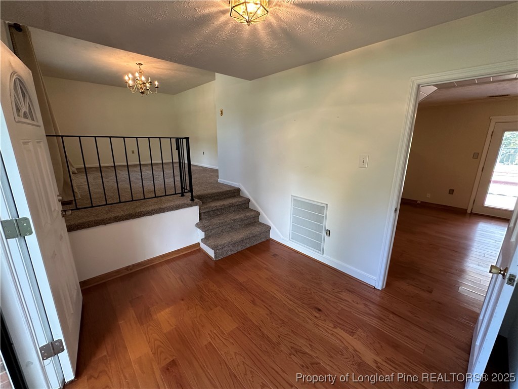3120 Hampstead Road Lumberton, NC 28360 - Photo 22 of 30 a view of a hallway with wooden floor and stairs