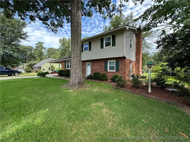 a front view of house with yard and green space