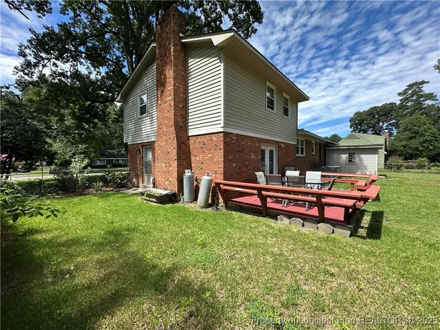 a backyard of a house with table and chairs
