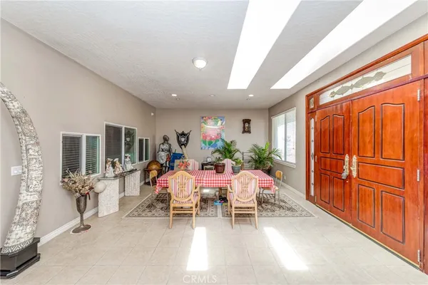 an open kitchen with wooden floor and refrigerator