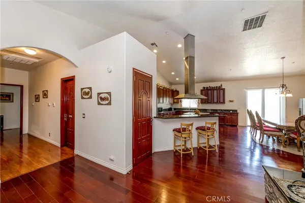 a kitchen with stainless steel appliances granite countertop a stove a sink dishwasher and cabinets with wooden floor