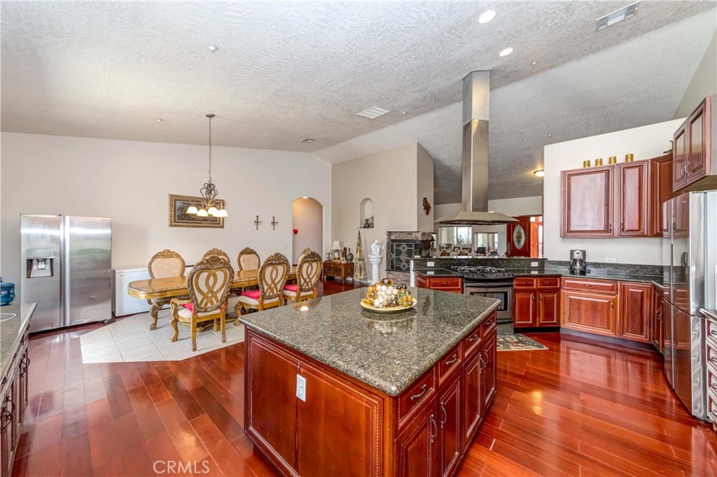 3789 Luna Road Phelan, CA 92371 - Photo 28 of 67 a kitchen with a stove kitchen island furniture and wooden floor