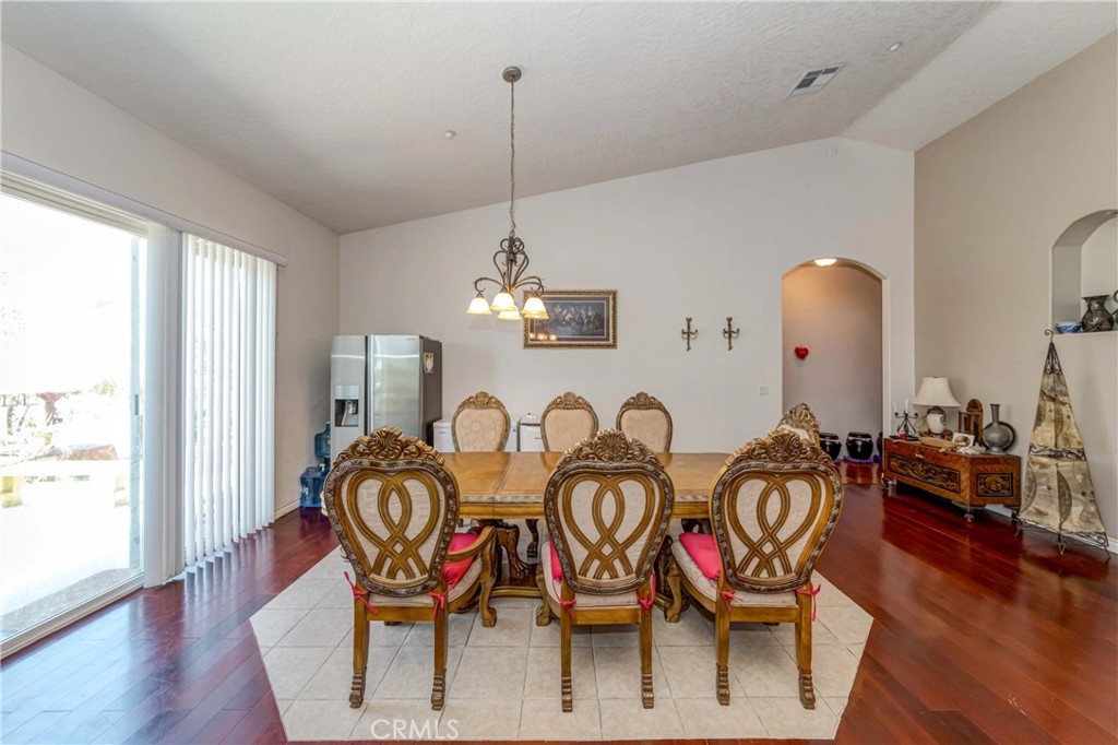 3789 Luna Road Phelan, CA 92371 - Photo 29 of 67 a view of a dining room with furniture wooden floor and chandelier