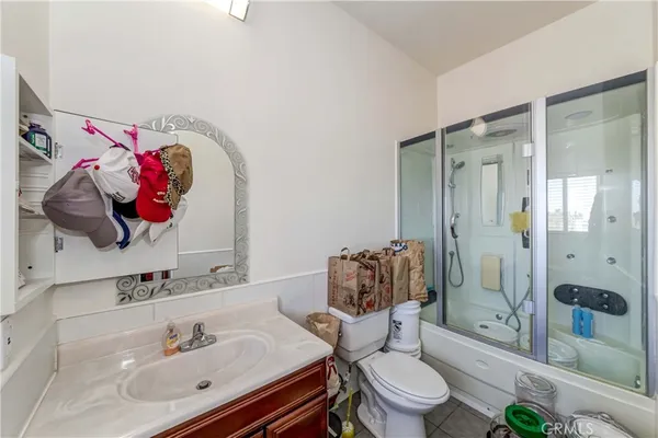 a bathroom with a sink mirror vanity and toilet