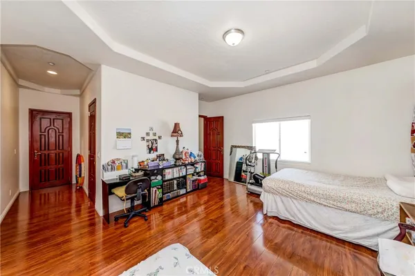 a bedroom with furniture and a wooden floor