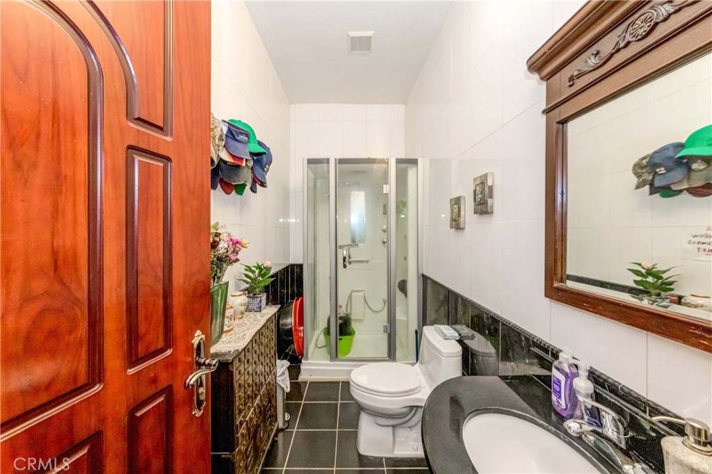 3789 Luna Road Phelan, CA 92371 - Photo 38 of 67 a white toilet sitting next to a bathroom sink and a mirror