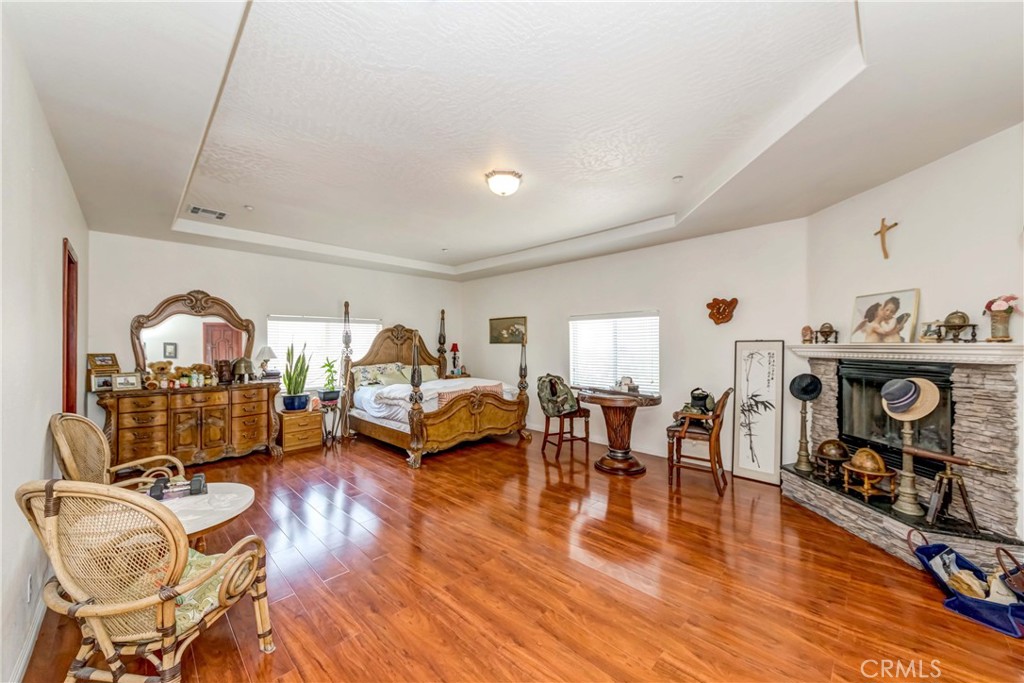 3789 Luna Road Phelan, CA 92371 - Photo 43 of 67 a living room with furniture a fireplace and gym equipment