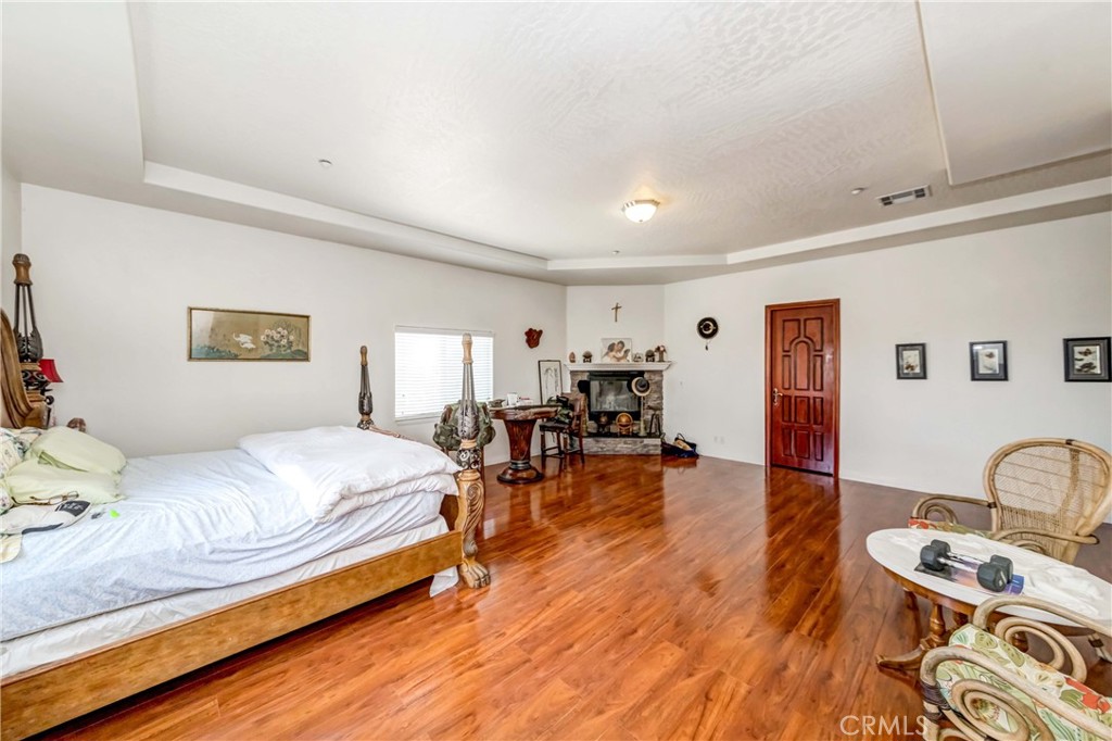 3789 Luna Road Phelan, CA 92371 - Photo 46 of 67 a bedroom with furniture and a wooden floor