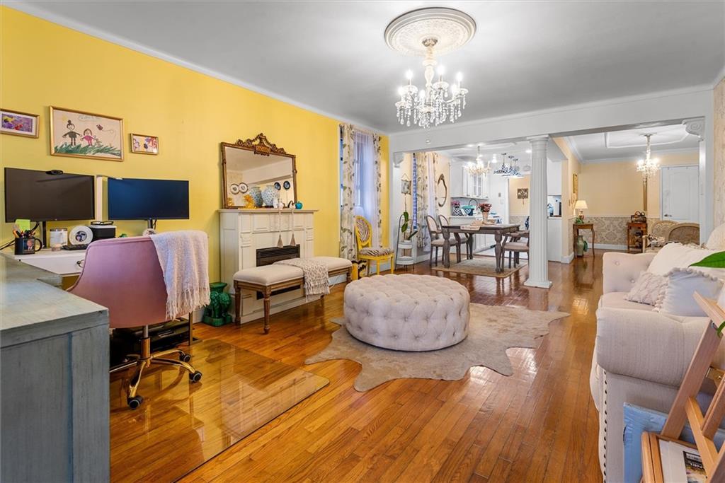 7401 Shore Road, Unit 1E Brooklyn, NY 11209 - Photo 11 of 21 a living room with fireplace furniture and a chandelier