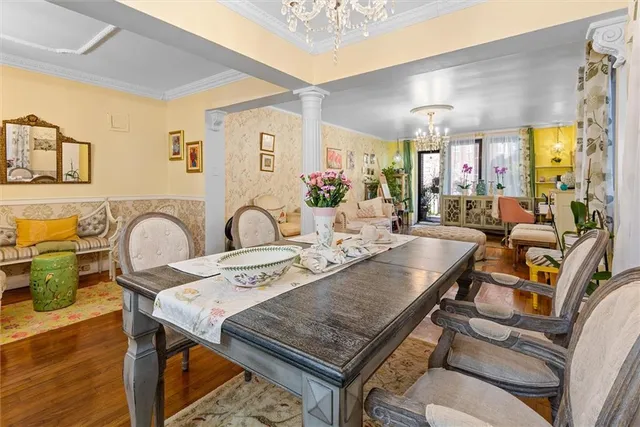 a view of a dining room with furniture and chandelier